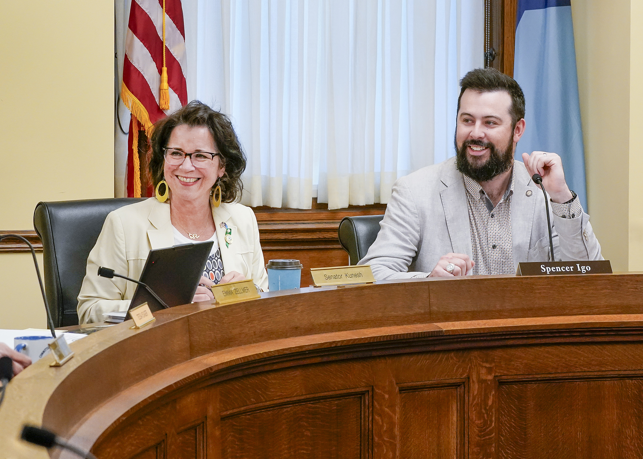 Sen. Mary Kunesh and Rep. Spencer Igo are all smiles listening to member and staff introductions to begin the May 13 conference committee for HF3900. (Photo by Andrew VonBank)